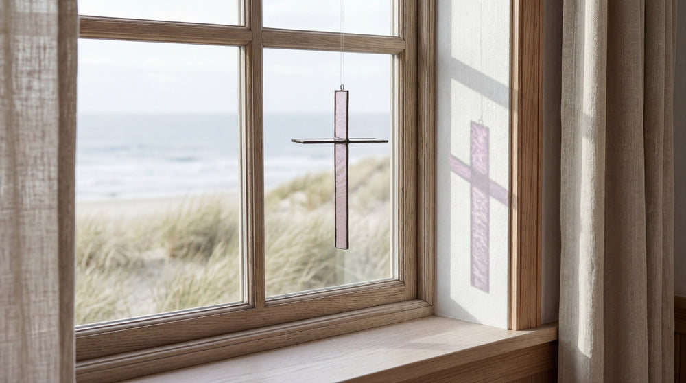 Rose Mist cross hanging in a coastal window